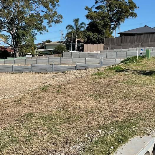 Grassy, Tiered Construction Site With Retaining Walls — Concrete Sleepers NSW - Port Macquarie in Sancrox, NSW