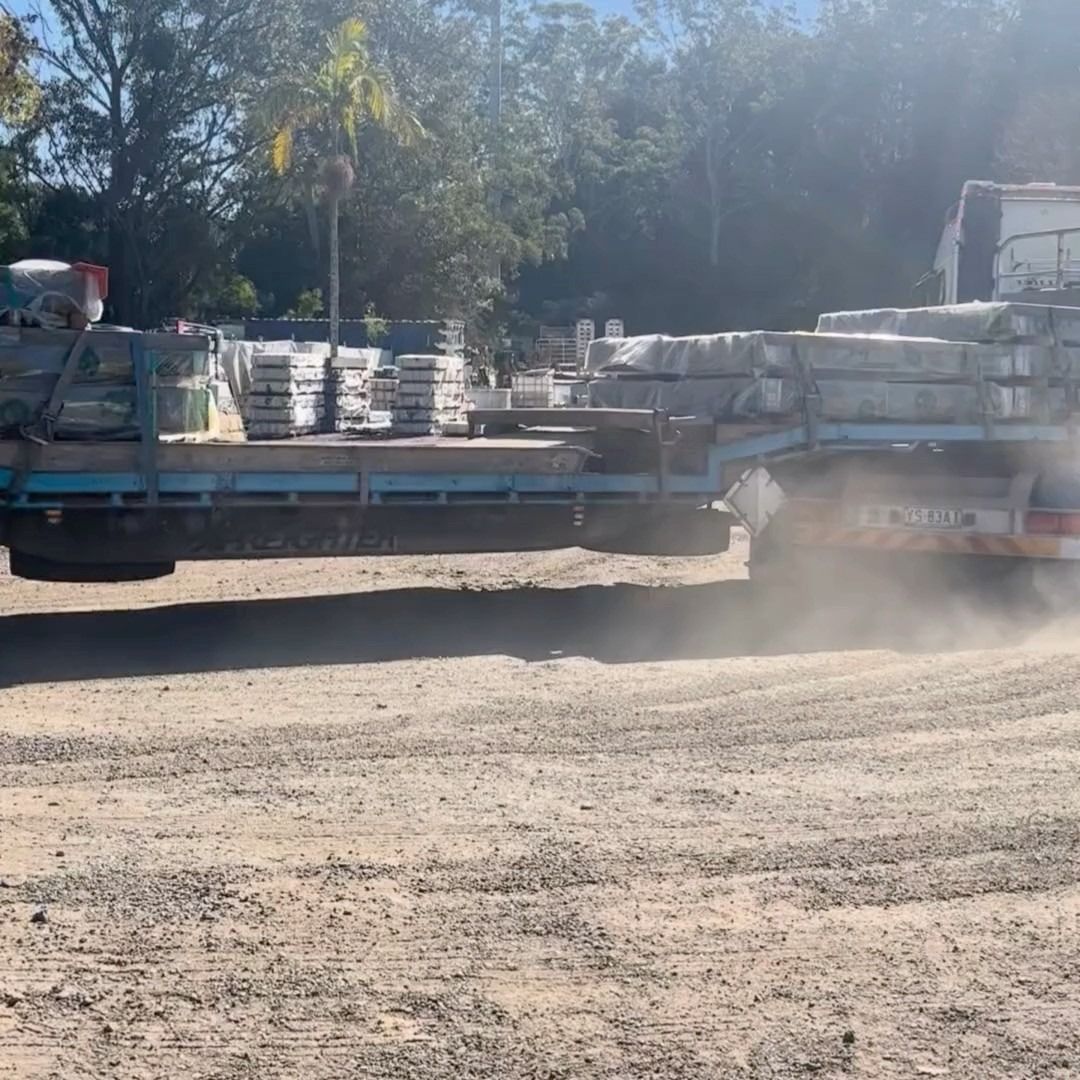 Truck Carrying Stacks of Stone Pavers on a Dirt Road — Concrete Sleepers NSW - Port Macquarie in Singleton, NSW