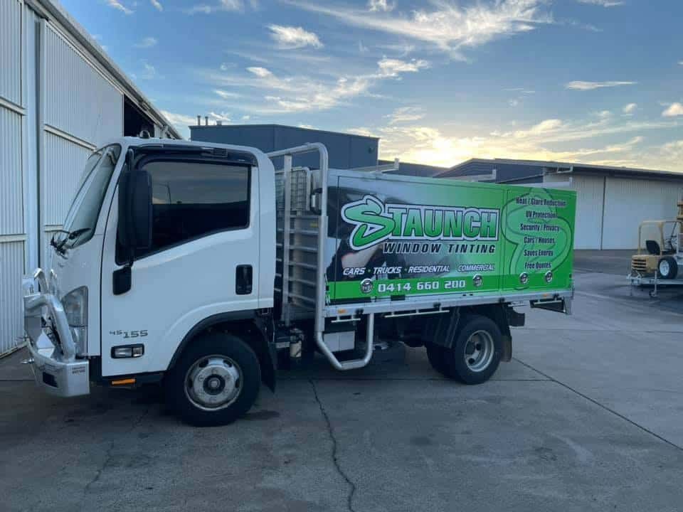 A White And Green Truck Is Parked In Front Of A Building — Staunch Window Tinting In South Lismore, NSW