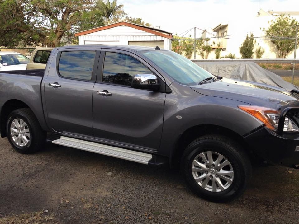 A Gray Truck Is Parked In Front Of A House — Staunch Window Tinting In South Lismore, NSW