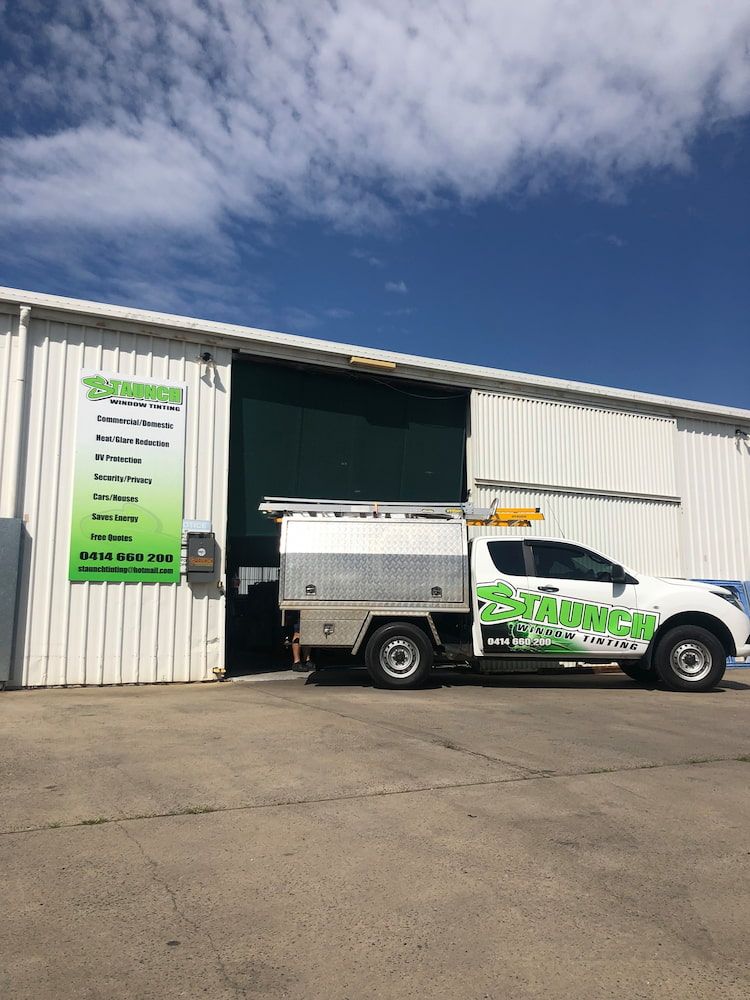 A White Truck Is Parked In Front Of A Building — Staunch Window Tinting In South Lismore, NSW