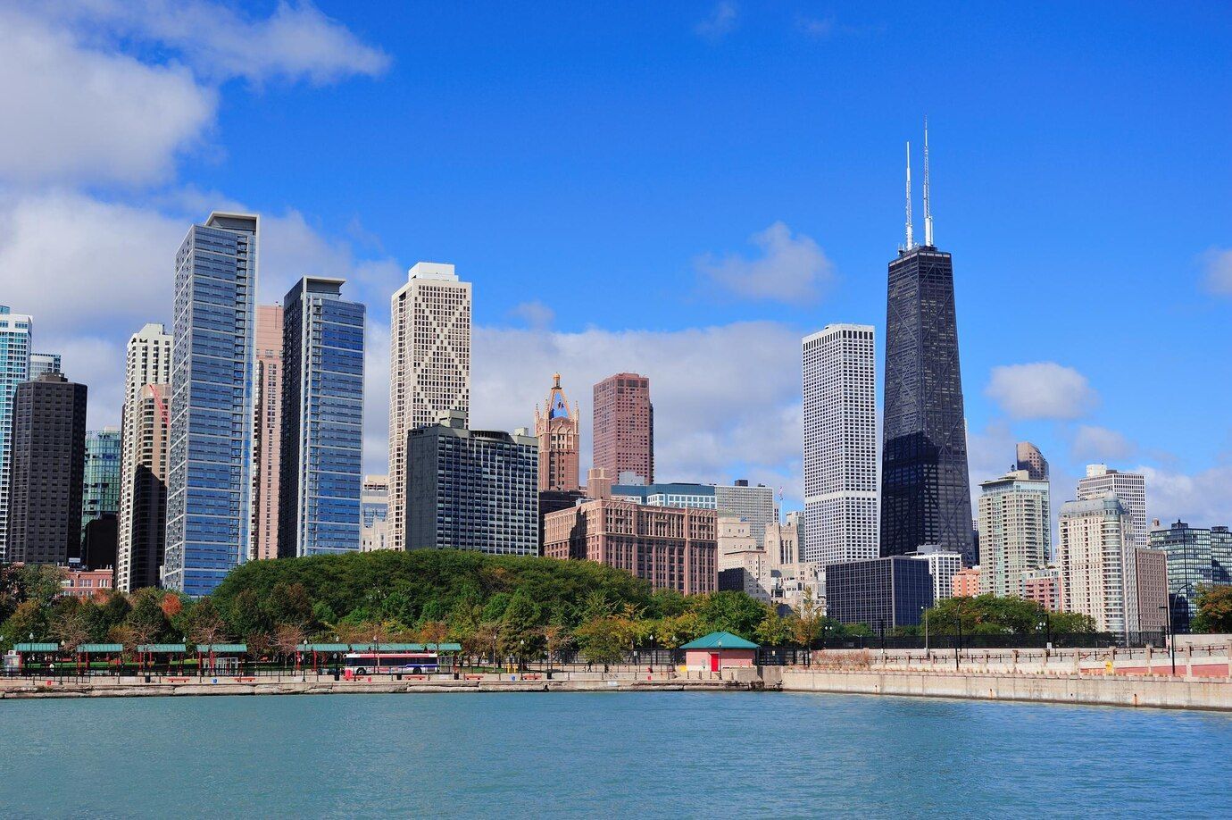 A city skyline with a lake in the foreground