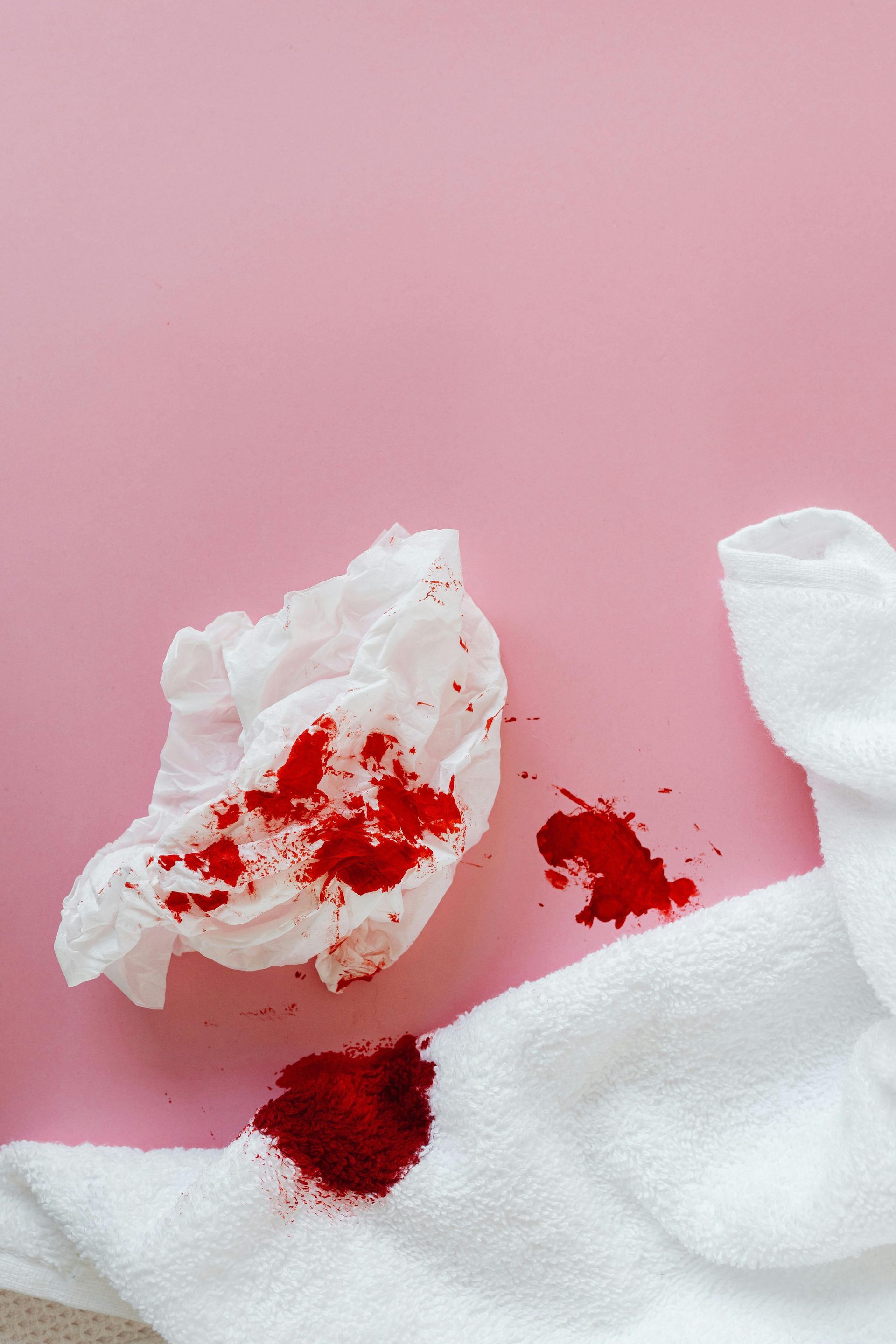 tissue on a tile floor with blood stains