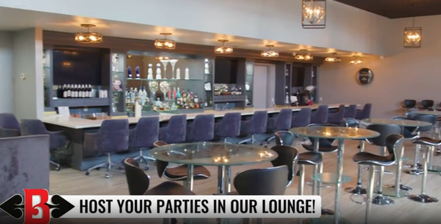 Bar lounge with purple stools, bar tables, and a “Host your parties in our lounge” sign