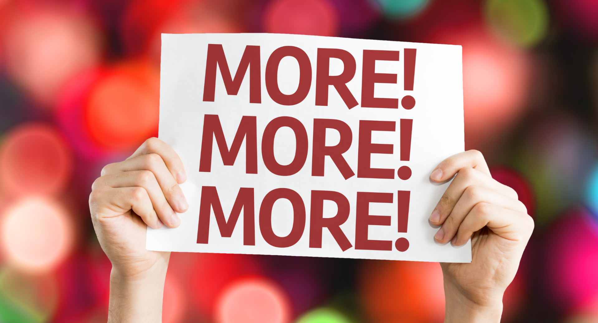 A person is holding a sign that says `` more ! more ! more ! ''