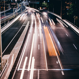 A long exposure photo of a highway at night