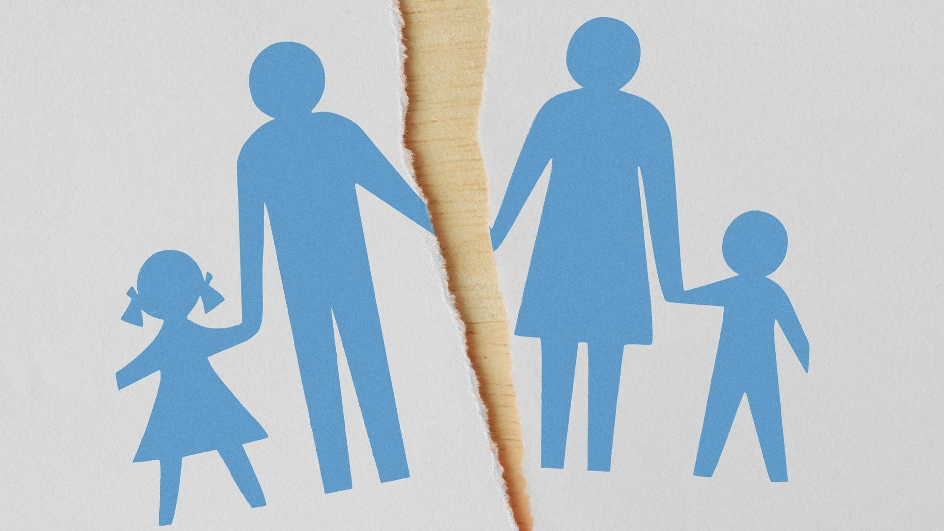 Paper cutout of a family torn apart, with a rip separating the parents and children.
