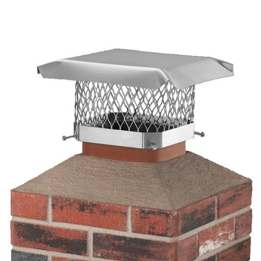 Chimney with brickwork, topped with a metal cap and mesh guard.