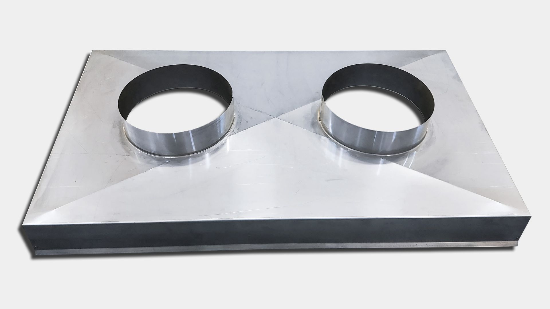 Metal HVAC duct with two circular openings on a rectangular surface.