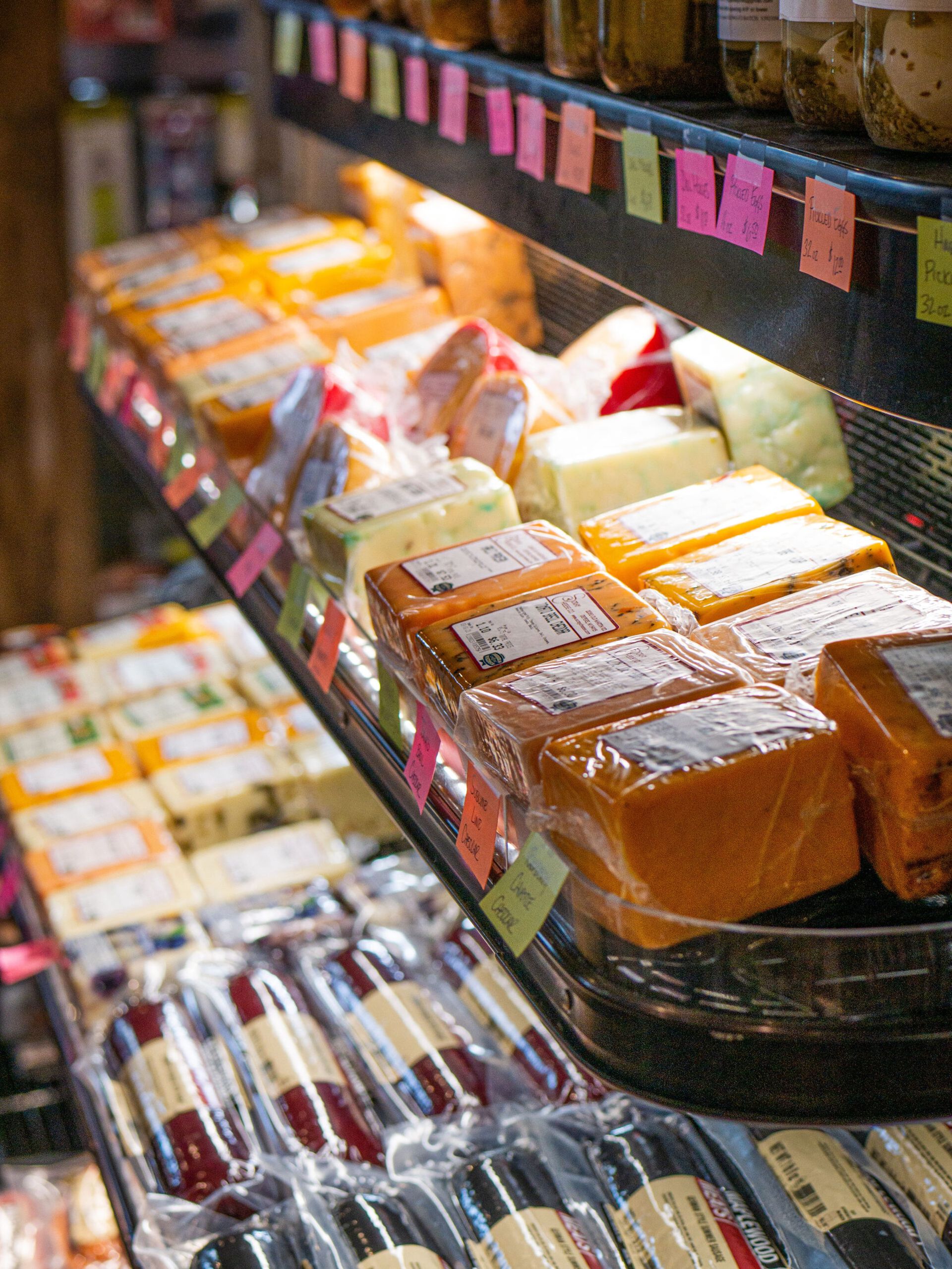 Rows of packaged baked goods in a grocery store bakery display case