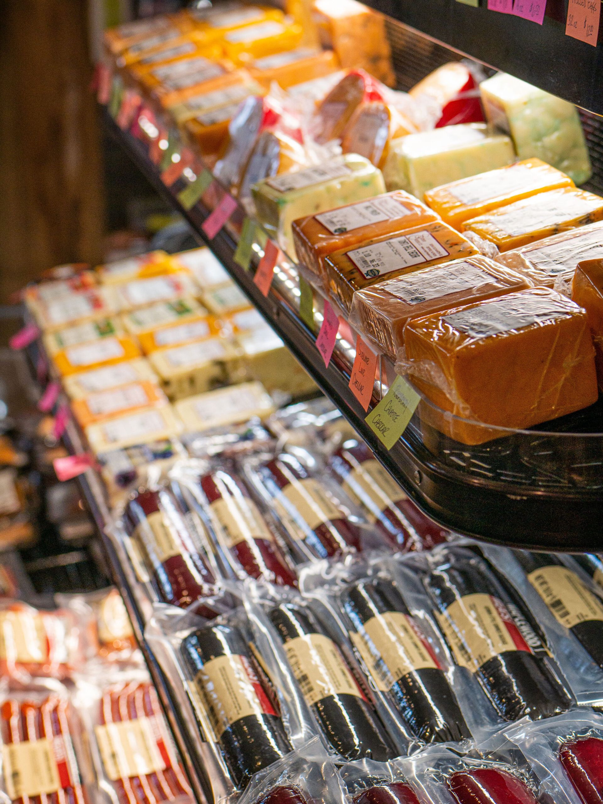 Assorted packaged sweets and rolled pastries displayed on a bakery shelf