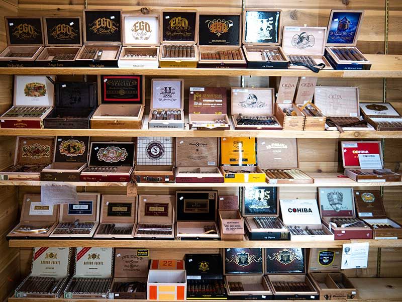 Rows of assorted packaged products on wooden shelves in a retail display