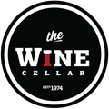 Round black logo for The Wine Cellar with white text, red “I,” and EST 1974.