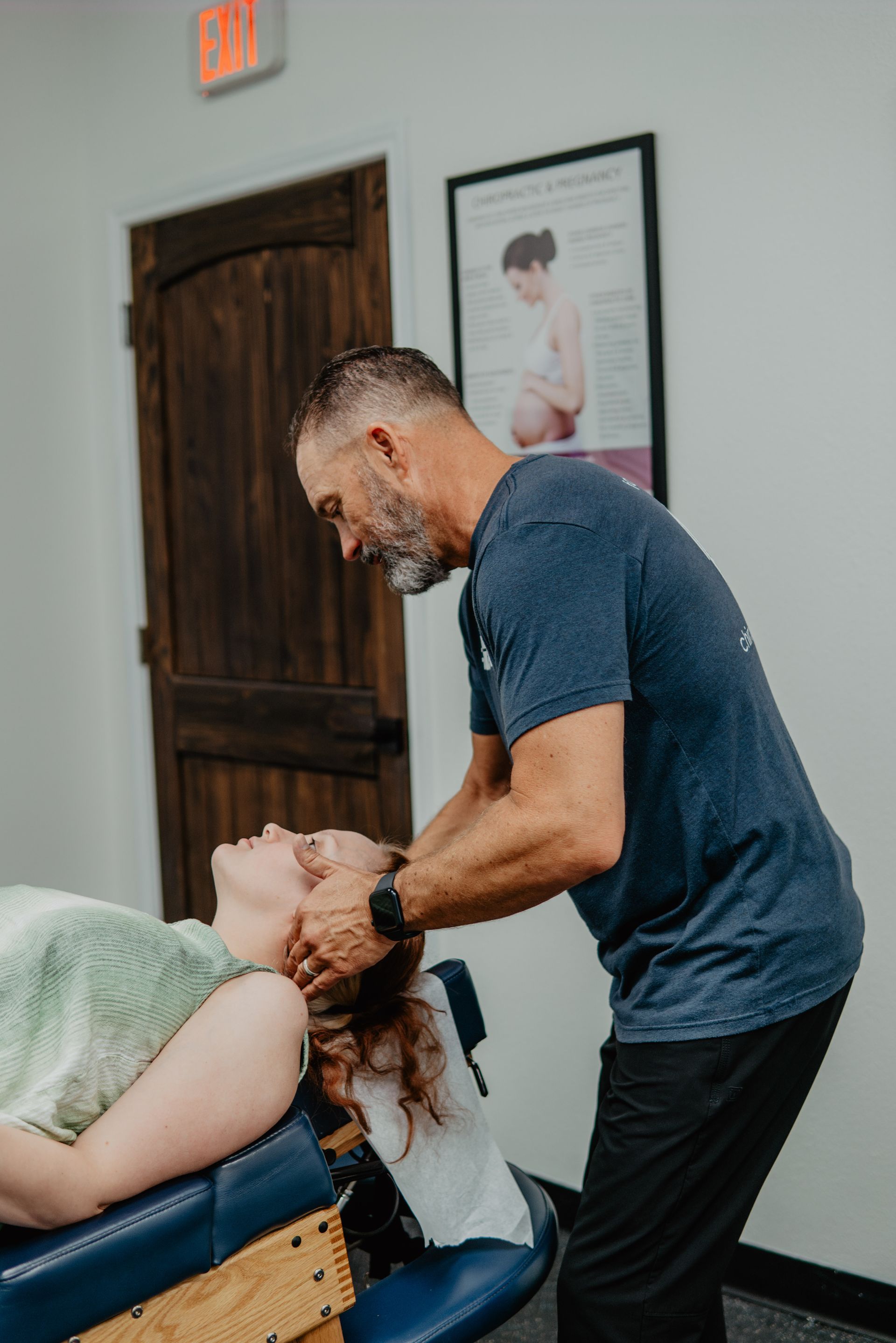 A man is giving a woman a neck massage.