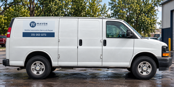 White service van with company logo parked on a wet street beside trees and a building.