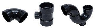 Black plastic plumbing pipe fittings and connectors on a white background