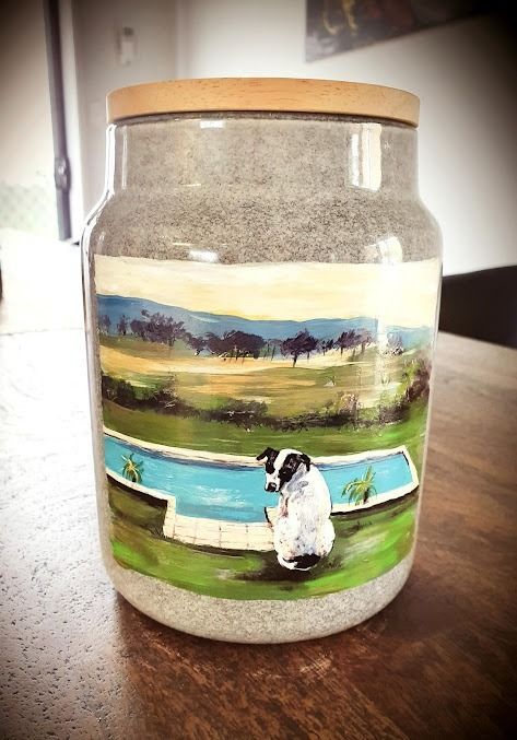 A Jar With A Picture Of A Sheep On It Is Sitting On A Wooden Table — Angels for Pets In Rockhampton, QLD