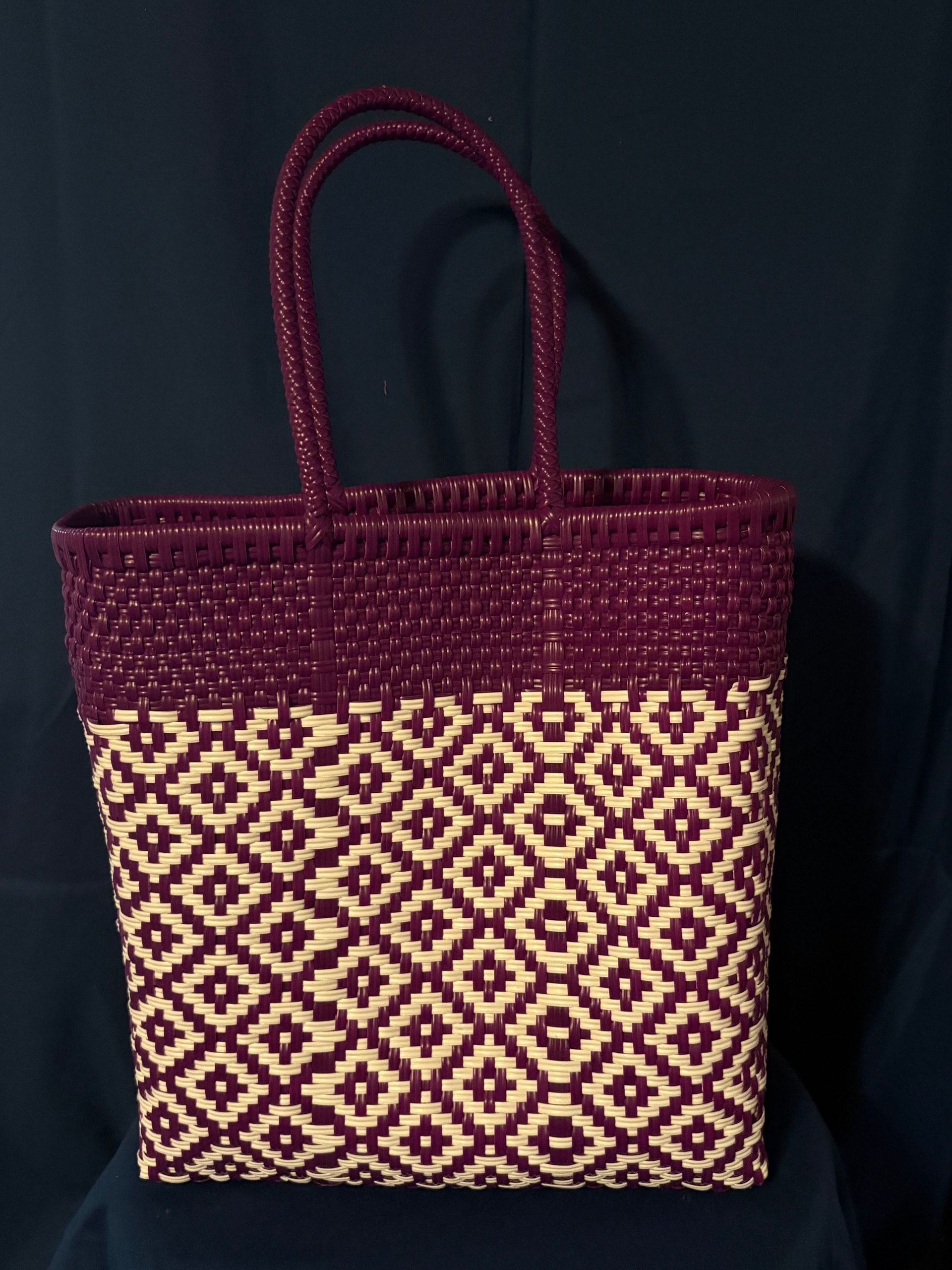 Purple woven tote bag with cream geometric pattern on a dark background