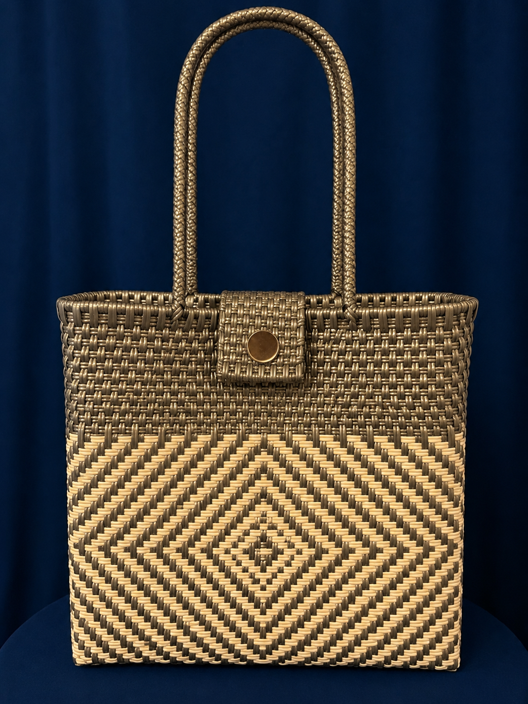 Black-and-cream woven tote bag with long handles and geometric pattern