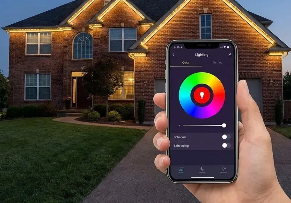 Hand holding smartphone controlling colorful outdoor house lights at dusk