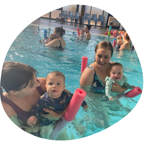 toddlers with their mom in a pool