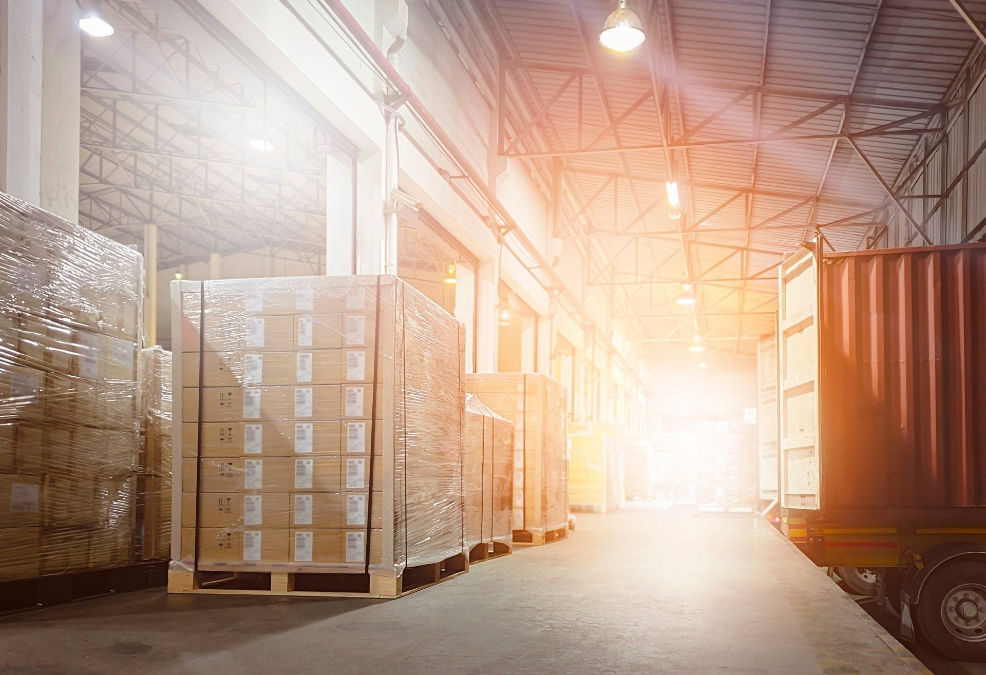 Stacked of Package Boxes on Pallets Loading with Shipping Cargo Container.