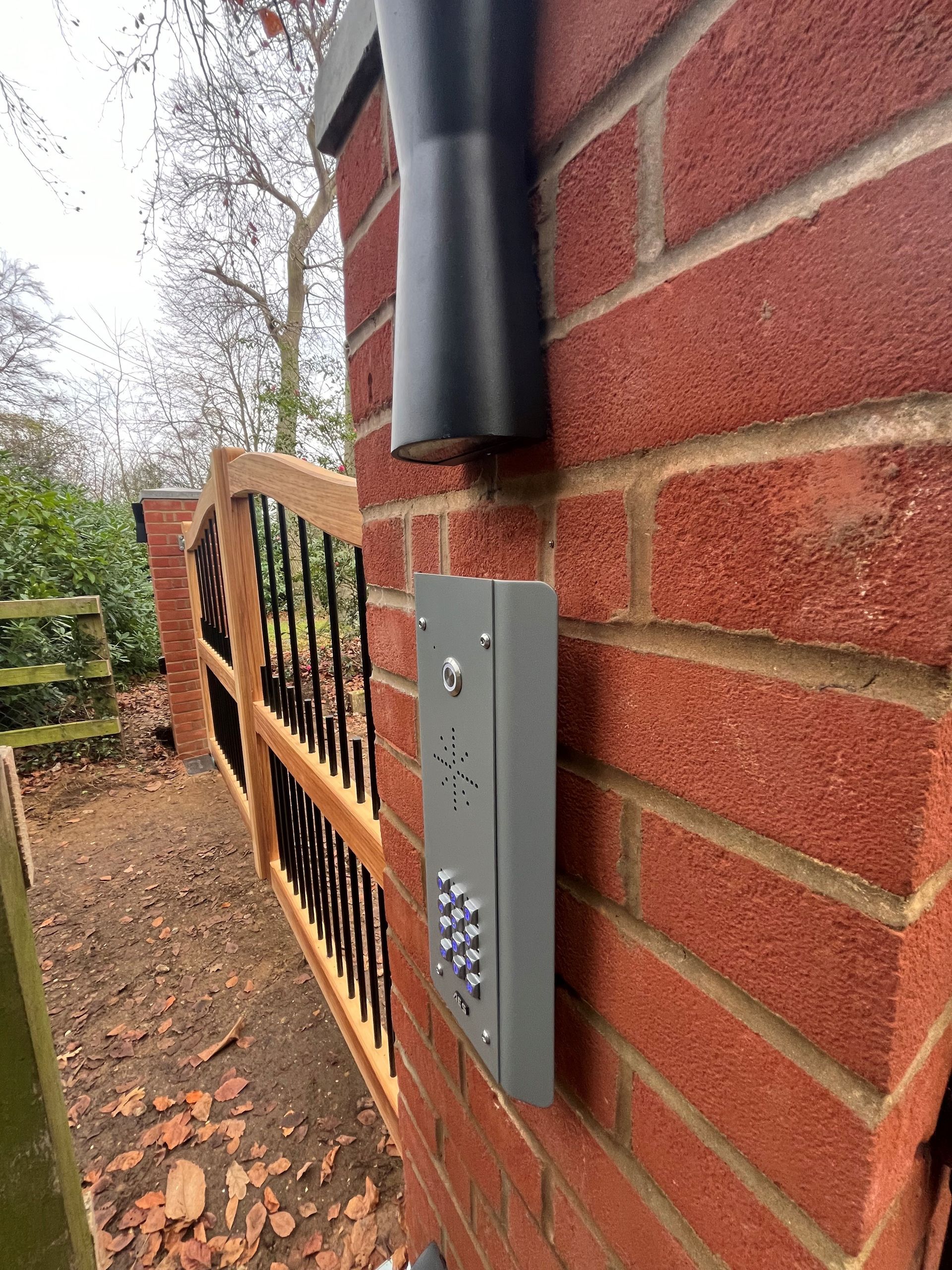 close up of timber Electric Gate and brick works its attched too