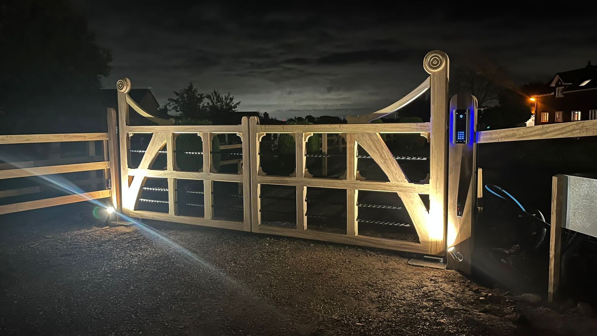 night time shot of farm style bespoke timber Electric Gate