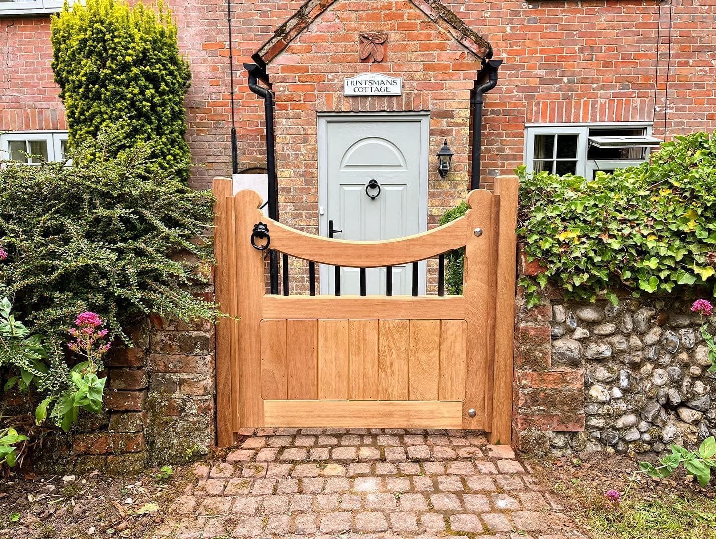 close up of timber front gate in front of front door to house 
