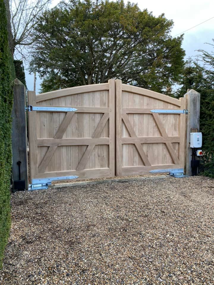 Electric Gate with large tree behind it 