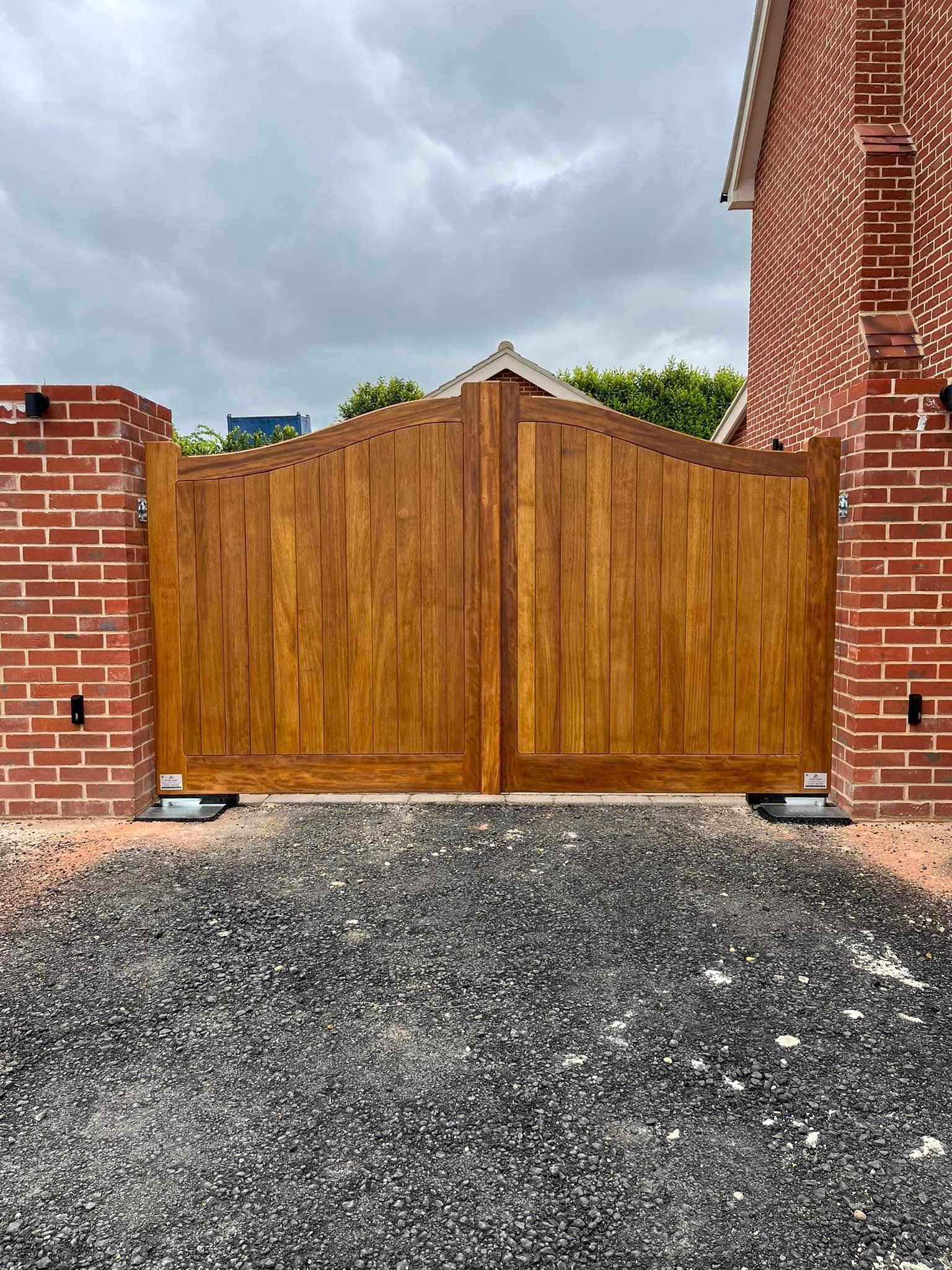 bespoke made timber Electric Gate attached to side of the house 