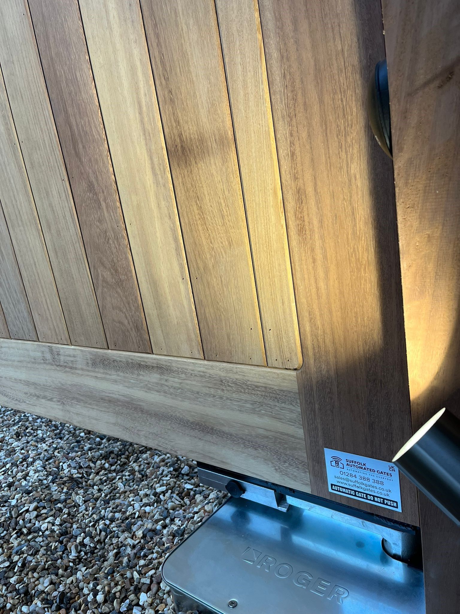 close up of timber cladding Electric Gate with light on it