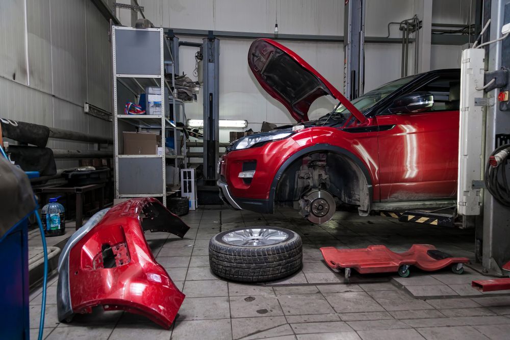 A Red Car is Parked in a Garage With Its Hood Open — Turbo's Tyres In Palmerston, NT