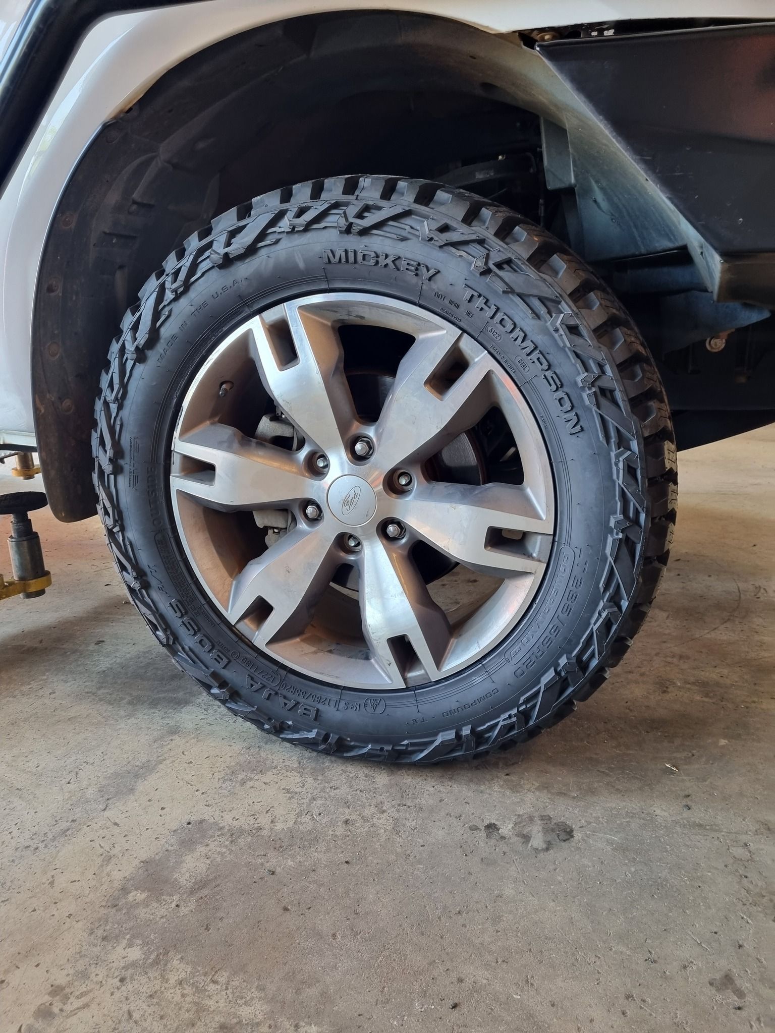 A Man is Working on a Tyre in a Garage — Turbo's Tyres In Humpty Doo, NT