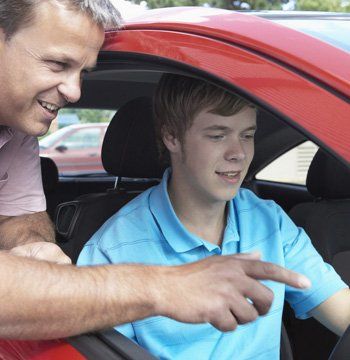 A man explaining something to a young boy