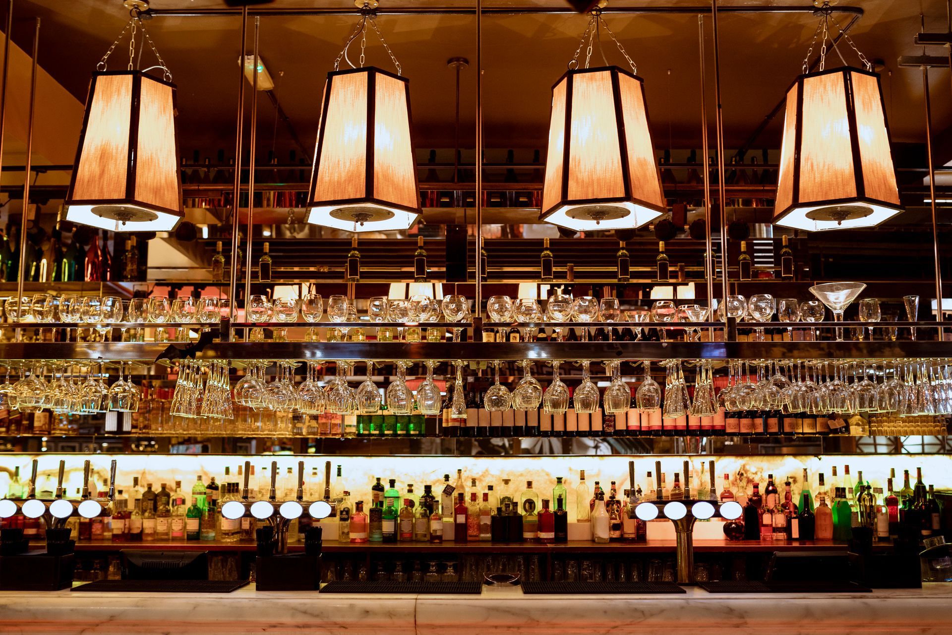 A bar filled with lots of bottles and glasses