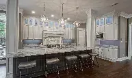 A large kitchen with a large island and stools.