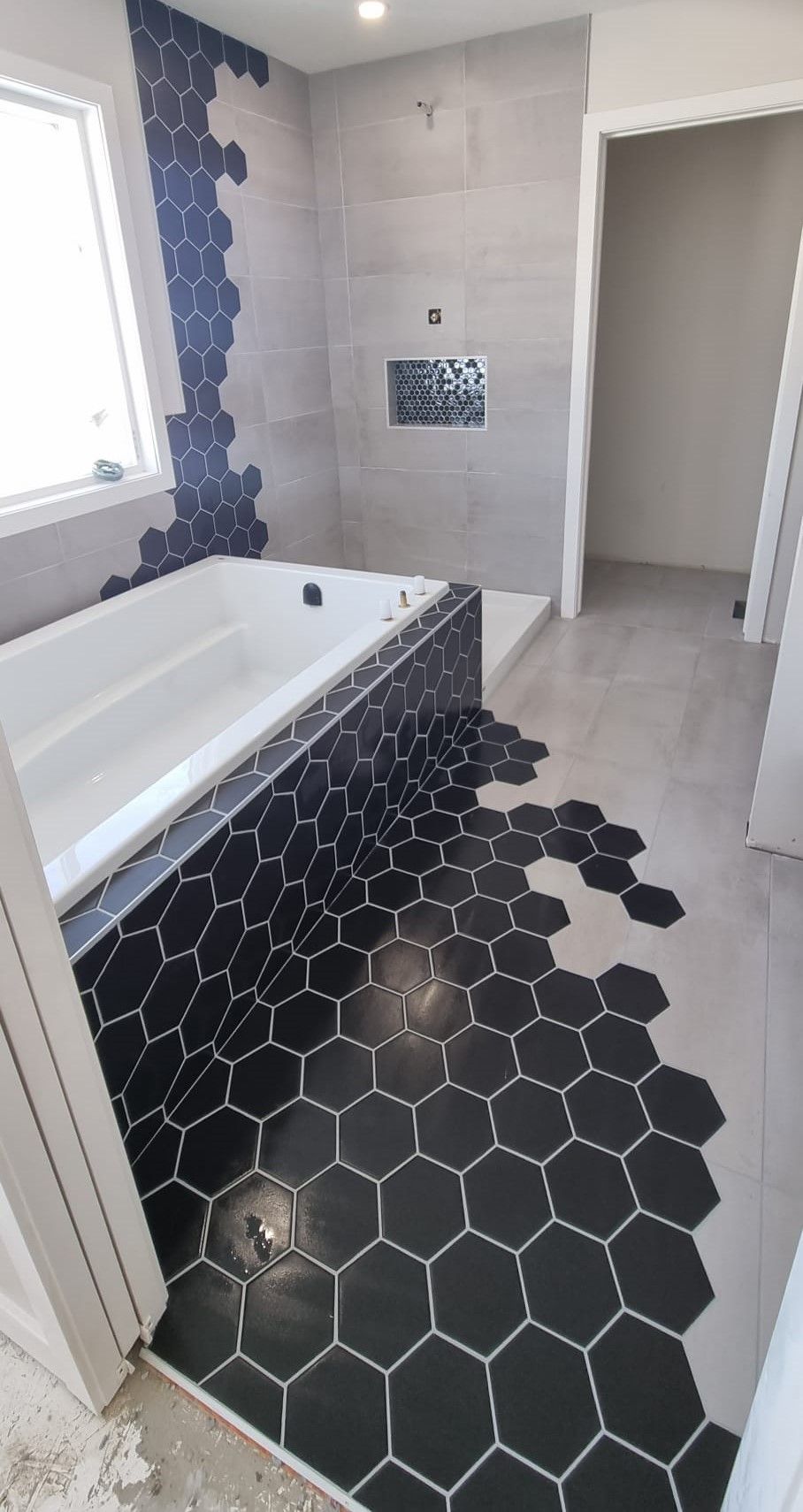 Modern Sherwood Park bathroom with a striking black and white hexagon tile design by XMP Construction.