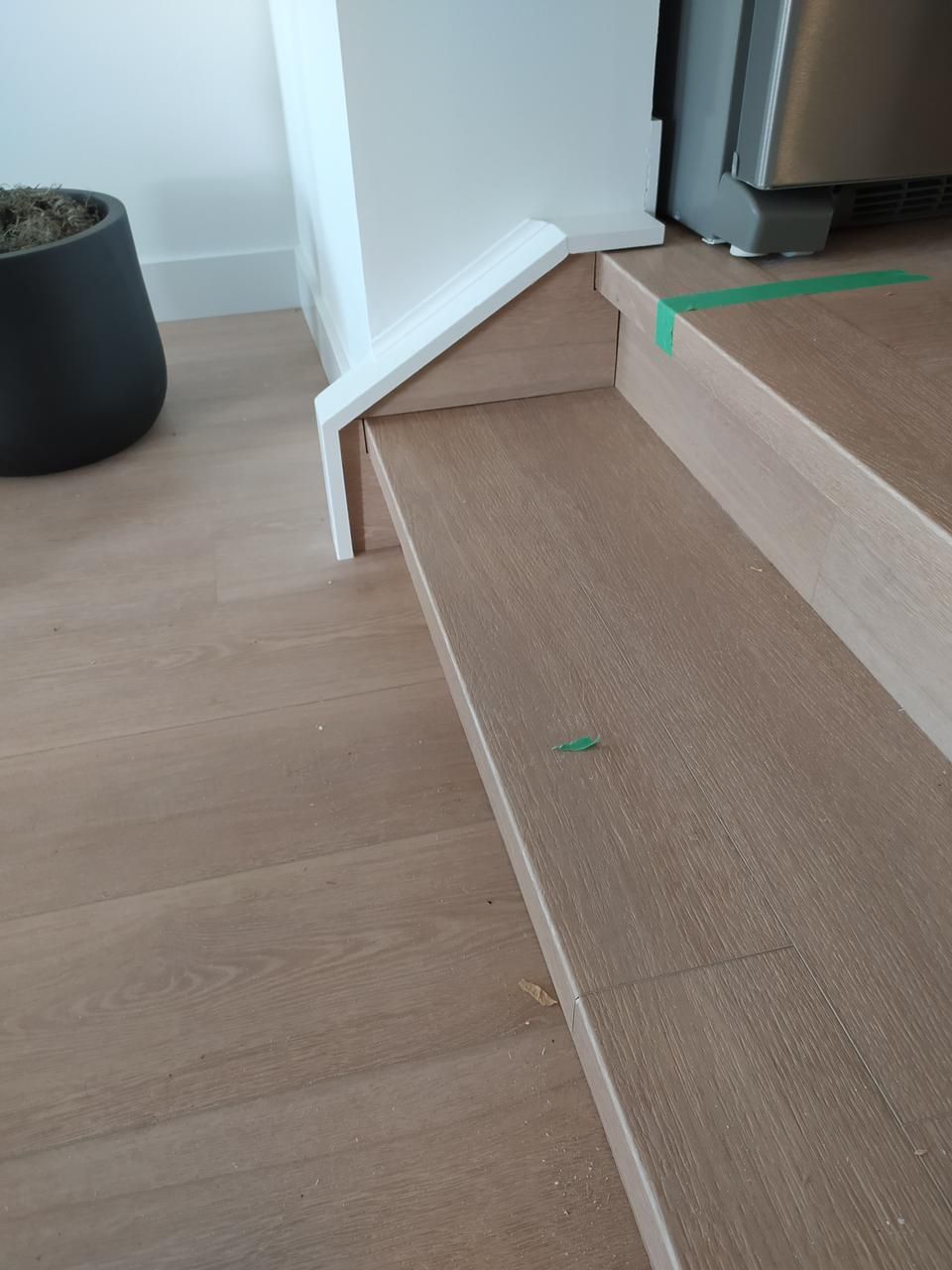 Installation of oak stairs laminate flooring in a Sherwood Park home by XMP Construction.