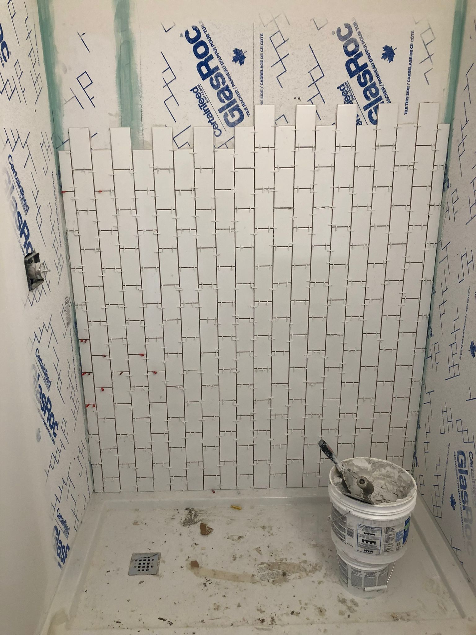 Installation of white picket tiles in a Sherwood Park shower by XMP Construction.