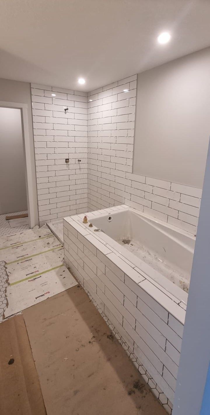 Installation of classic white subway tiles in a Sherwood Park bathroom by XMP Construction.