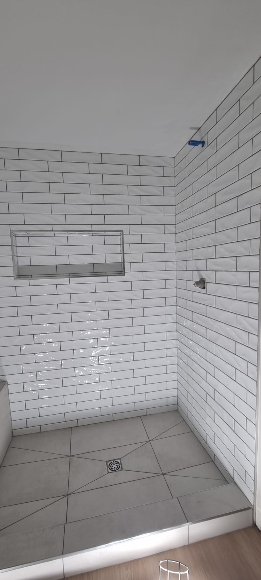 Bright Sherwood Park shower with classic white subway tiles by XMP Construction.
