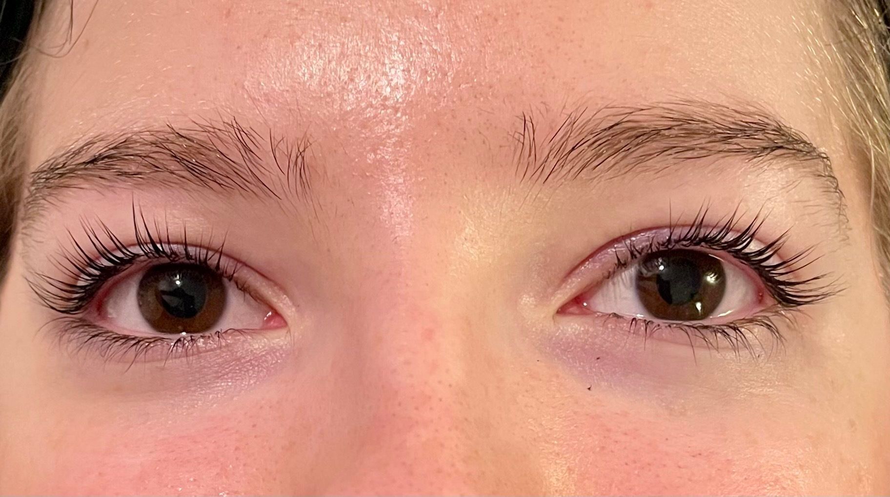 a close up of a woman 's eyes with long eyelashes