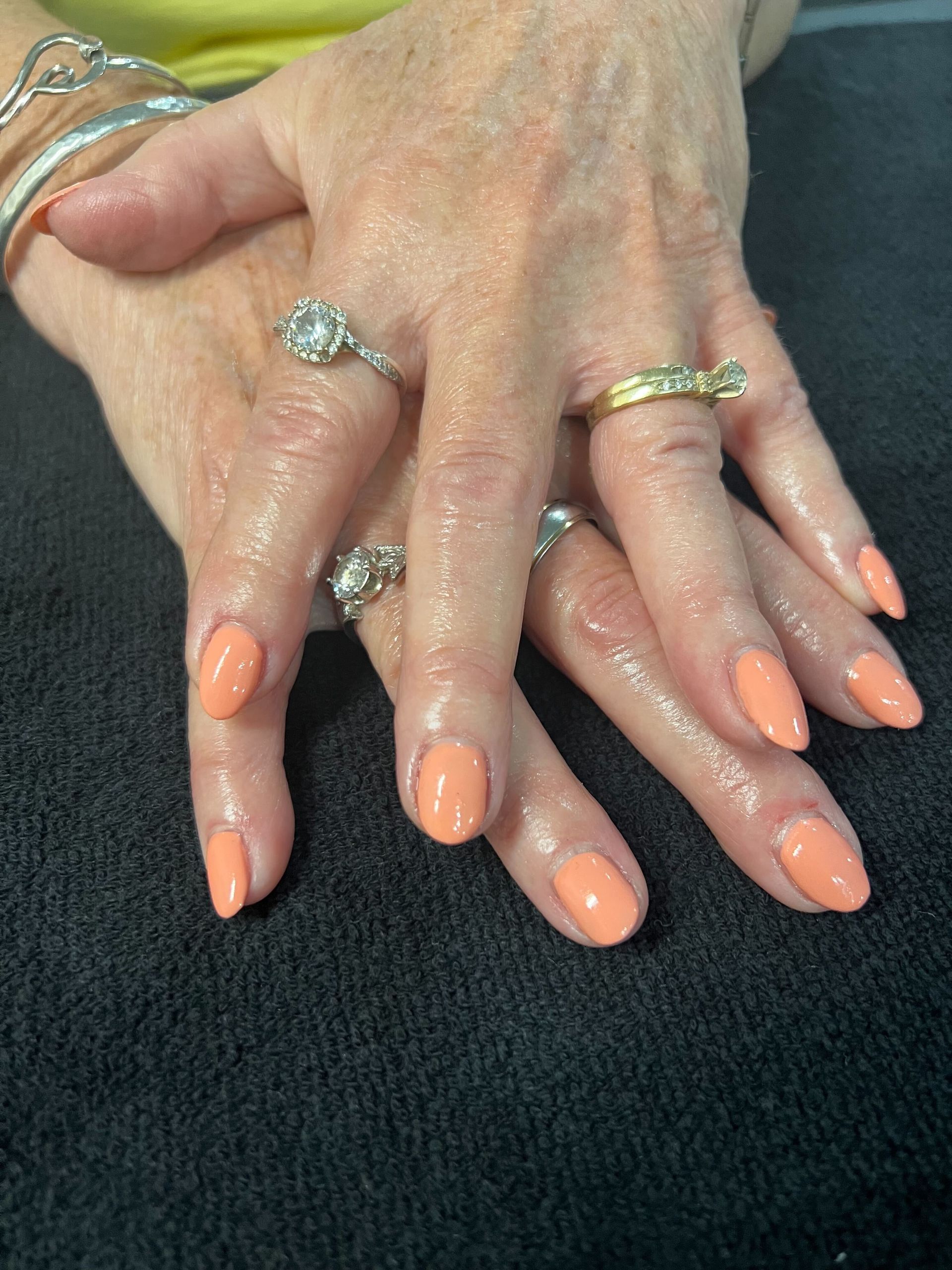 a close up of a woman 's hands with rings on them