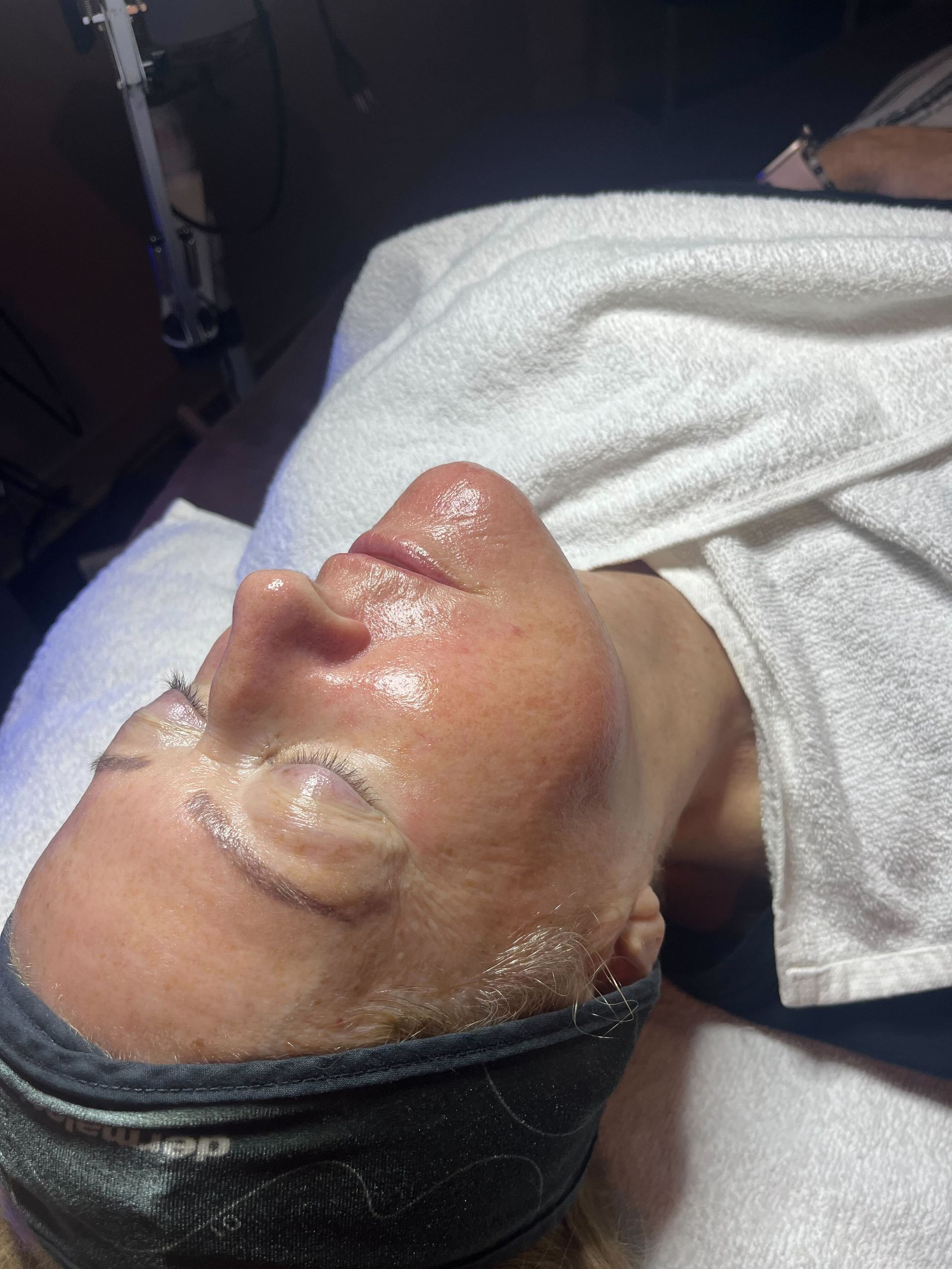a woman wearing a headband getting facial