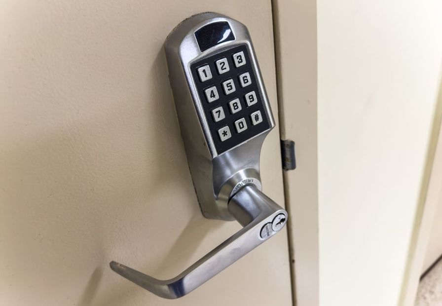 Digital keypad door lock with lever handle on a beige door