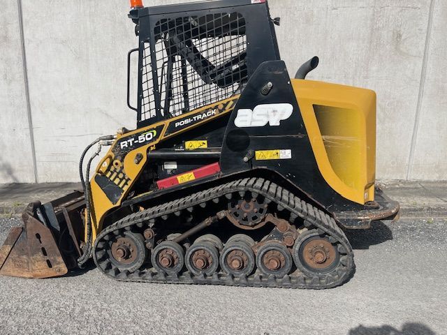 A yellow and black tractor with the word esp on it