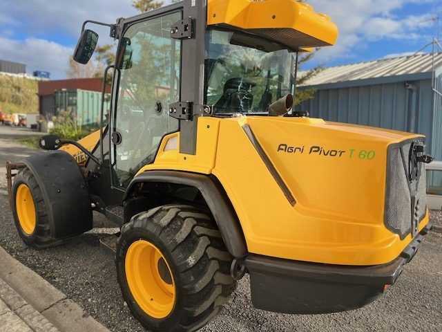 A yellow tractor with the word pivot on the side