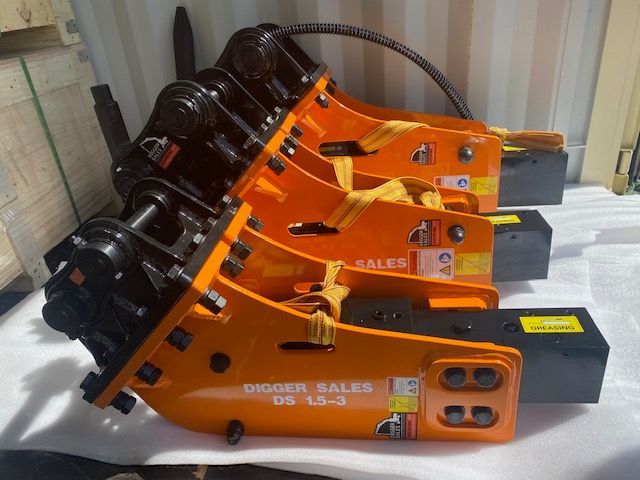 A row of digger sales hammers are lined up on a table