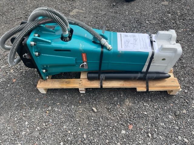 A blue and white machine is sitting on a wooden pallet.